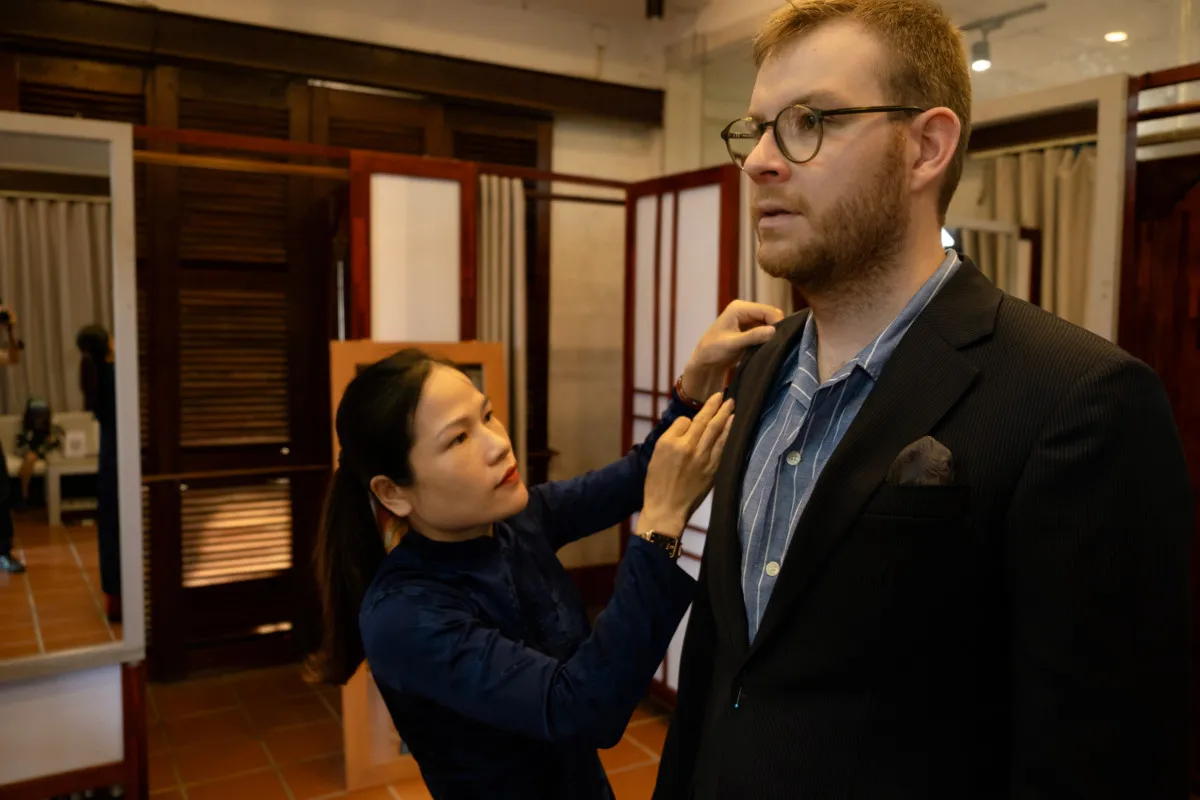 Master Tailor measuring bespoke garments in Hoi An Ancient Town